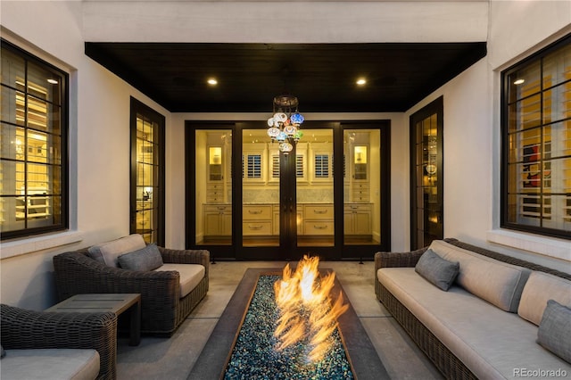 view of patio with an outdoor living space with a fire pit