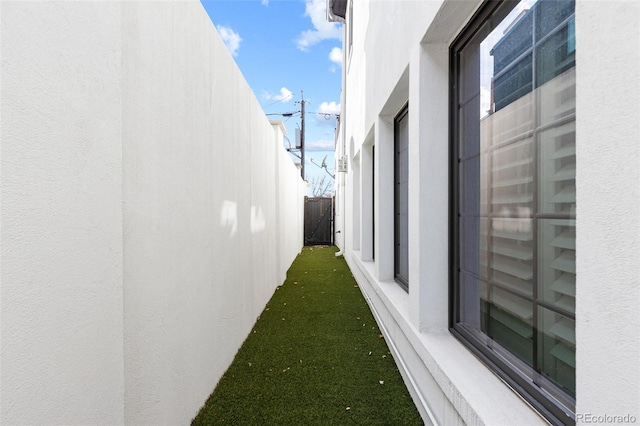 view of property exterior with a lawn and stucco siding