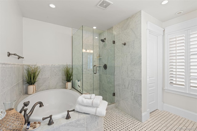 bathroom featuring a garden tub, recessed lighting, visible vents, baseboards, and a stall shower