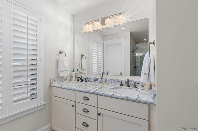 full bath featuring a stall shower, a sink, and double vanity