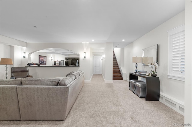 living room featuring carpet, visible vents, stairway, and recessed lighting