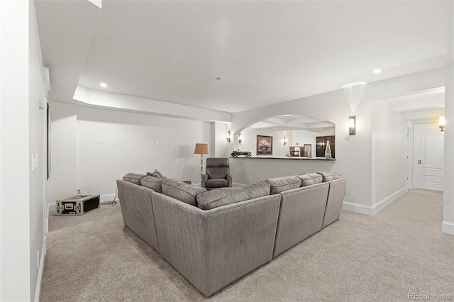 living room featuring light carpet, baseboards, and recessed lighting