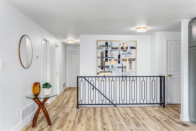 7120 S Sheridan Ct, Littleton, CO 80128 - corridor with light wood finished floors, baseboards, and an upstairs landing