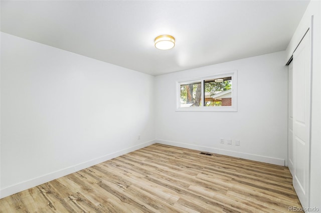 7120 S Sheridan Ct, Littleton, CO 80128 - unfurnished bedroom featuring baseboards, a closet, and light wood-style flooring