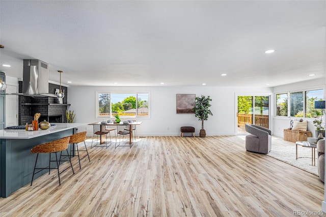 7120 S Sheridan Ct, Littleton, CO 80128 - living room with light wood-style floors, recessed lighting, baseboards, and a brick fireplace