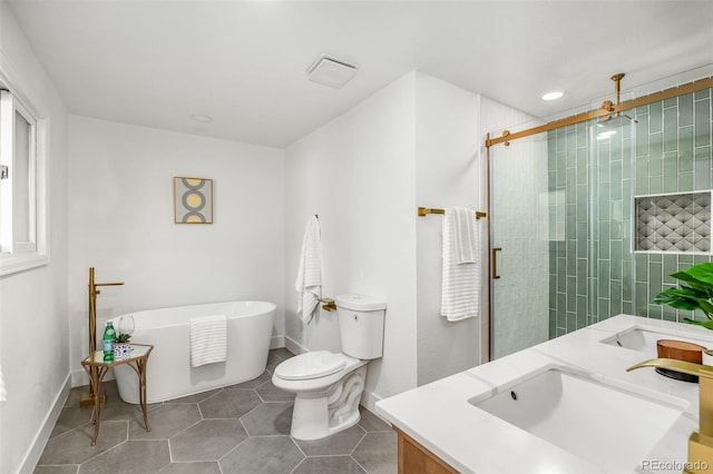 7120 S Sheridan Ct, Littleton, CO 80128 - full bath featuring double vanity, a freestanding bath, a stall shower, tile patterned floors, and recessed lighting