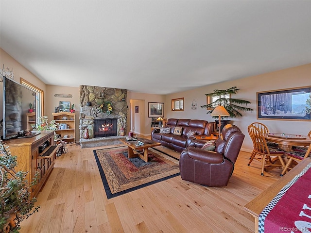 living room with wood-type flooring and a fireplace