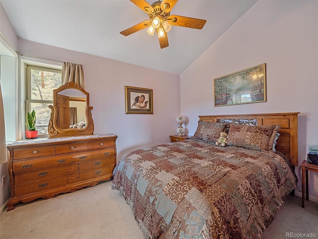 bedroom featuring ceiling fan, vaulted ceiling, and light colored carpet