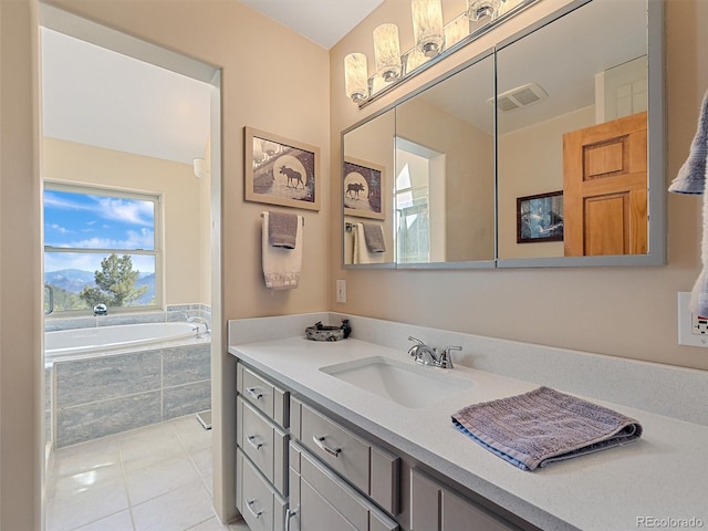full bath featuring visible vents, tile patterned flooring, vanity, and a bath