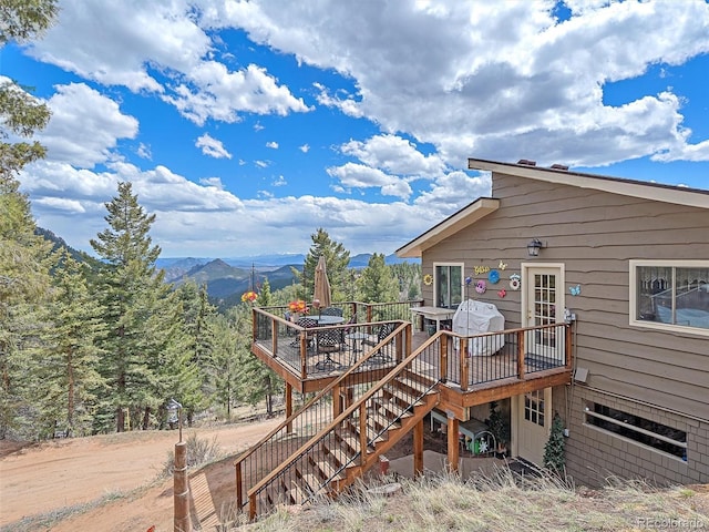 wooden terrace with stairway and a mountain view