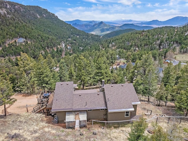 aerial view with a mountain view and a view of trees