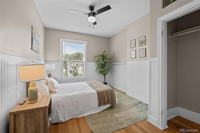 14 S Lincoln St Unit 16, Denver, CO 80209 - bedroom featuring wainscoting, wood finished floors, and ceiling fan