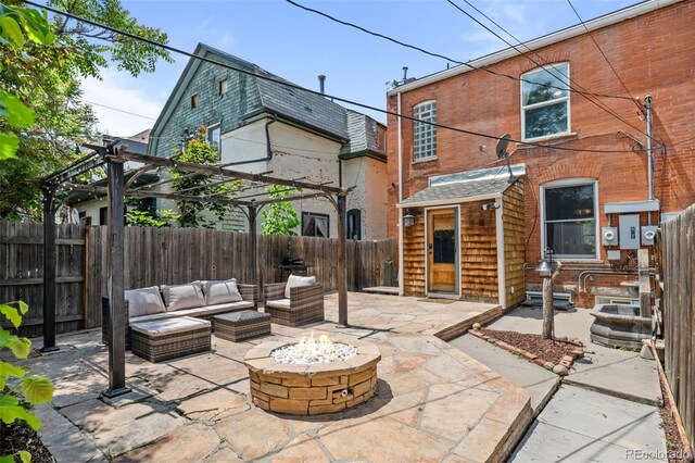 14 S Lincoln St Unit 16, Denver, CO 80209 - back of house with a fenced backyard, a pergola, a patio area, and an outdoor living space with a fire pit