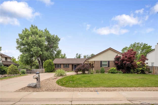 5292 W Fair Dr, Littleton, CO 80123 - view of front facade featuring concrete driveway and brick siding