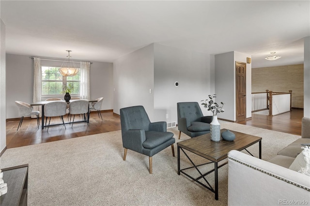 5292 W Fair Dr, Littleton, CO 80123 - carpeted living room featuring baseboards and wood finished floors