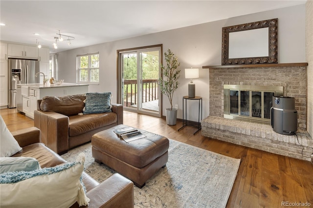 5292 W Fair Dr, Littleton, CO 80123 - living area featuring light wood-style flooring, a fireplace, and recessed lighting