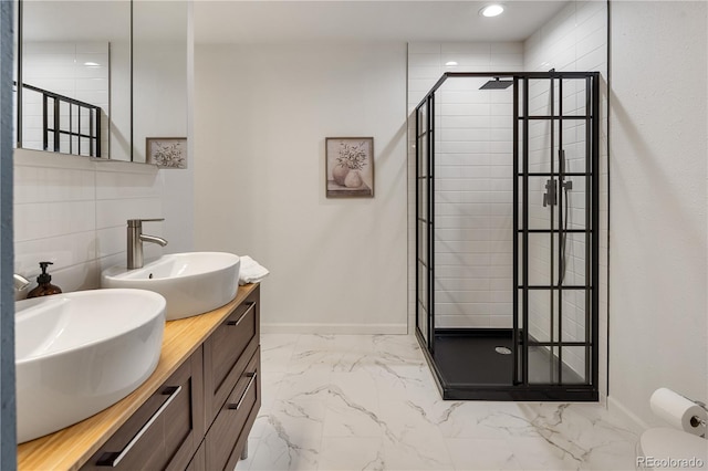5292 W Fair Dr, Littleton, CO 80123 - full bathroom with a stall shower, double vanity, marble finish floors, and recessed lighting