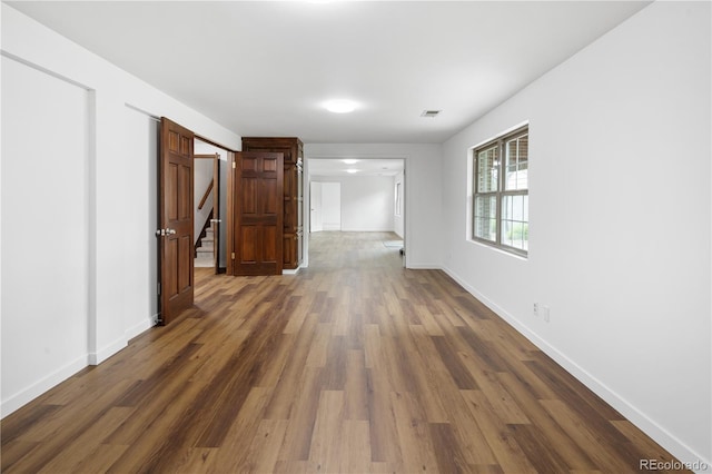 5292 W Fair Dr, Littleton, CO 80123 - empty room featuring dark wood-style flooring and stairs