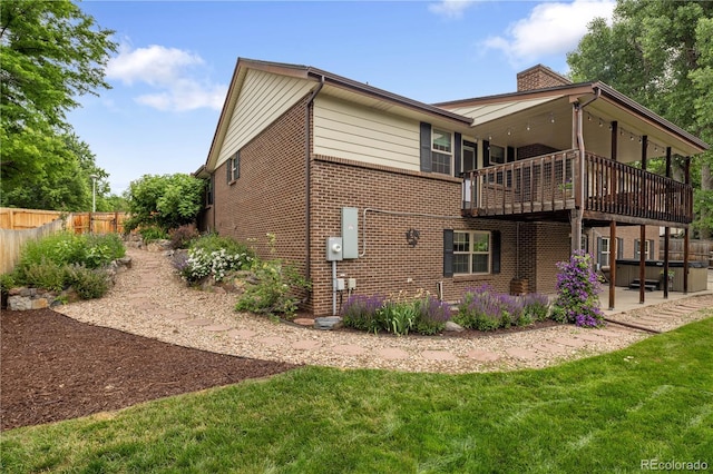5292 W Fair Dr, Littleton, CO 80123 - back of house featuring brick siding, a patio area, a chimney, and a balcony