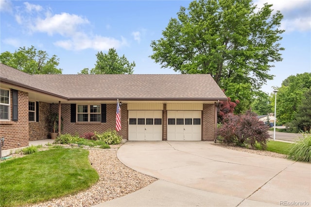 5292 W Fair Dr, Littleton, CO 80123 - view of front of property featuring an attached garage, brick siding, concrete driveway, a front lawn, and roof with shingles