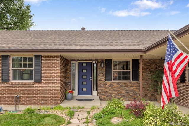 5292 W Fair Dr, Littleton, CO 80123 - property entrance with roof with shingles and brick siding