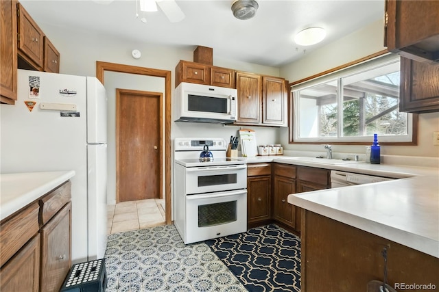 670 Wapiti Dr, Fraser, CO 80442 - kitchen with white appliances, light countertops, a ceiling fan, a sink, and brown cabinets