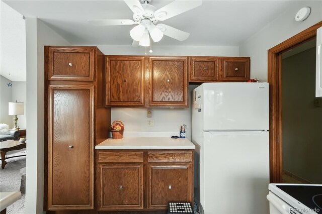 670 Wapiti Dr, Fraser, CO 80442 - kitchen with white appliances, ceiling fan, light countertops, and brown cabinets