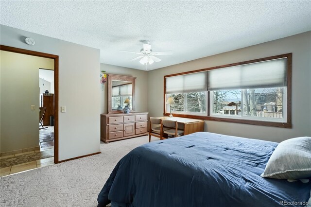 670 Wapiti Dr, Fraser, CO 80442 - bedroom featuring carpet floors, a textured ceiling, baseboards, and a ceiling fan