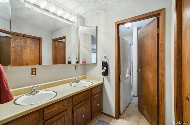 670 Wapiti Dr, Fraser, CO 80442 - full bathroom with a textured ceiling, double vanity, and tile patterned floors