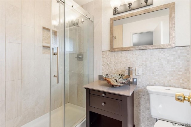 591 Nome St, Aurora, CO 80010 - full bathroom with a stall shower, vanity, backsplash, and tile walls