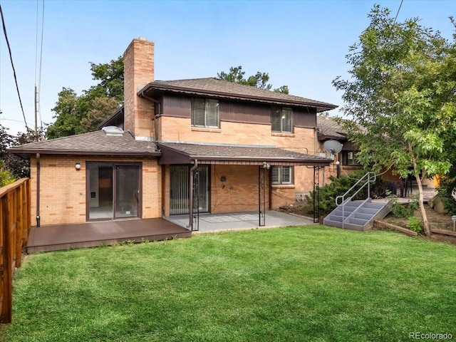 591 Nome St, Aurora, CO 80010 - back of house with a patio, a chimney, a lawn, and brick siding