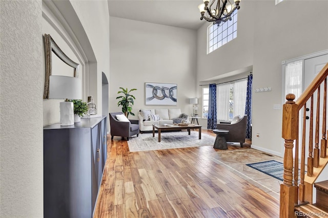 entrance foyer with a high ceiling, an inviting chandelier, and light hardwood / wood-style flooring