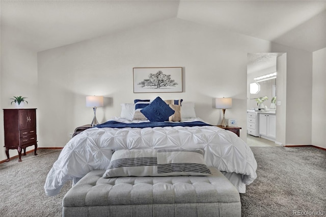 bedroom featuring light carpet, vaulted ceiling, and ensuite bathroom