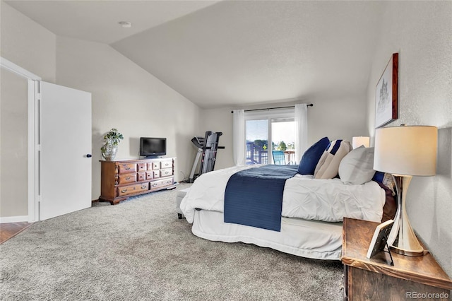 carpeted bedroom featuring vaulted ceiling and access to exterior