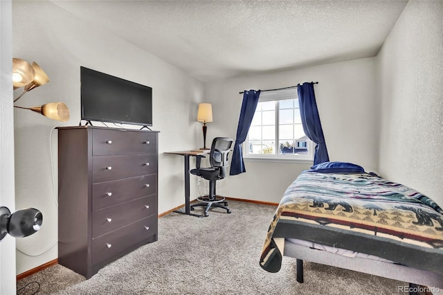 carpeted bedroom featuring a textured ceiling