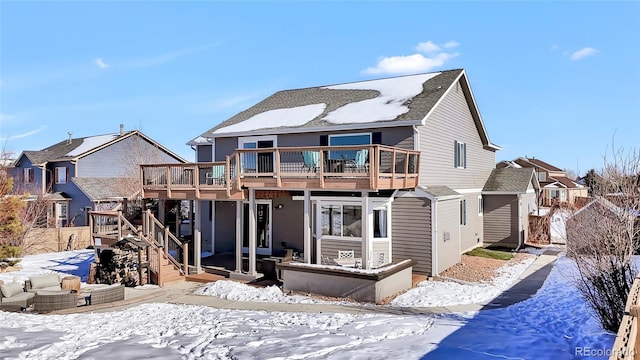 snow covered house with a deck