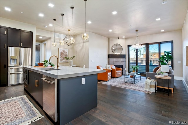 302 N Meldrum St Unit 206, Fort Collins, CO 80521 - kitchen featuring stainless steel appliances, a sink, light countertops, dark wood-type flooring, and recessed lighting