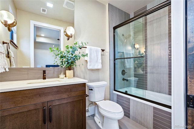 302 N Meldrum St Unit 206, Fort Collins, CO 80521 - full bathroom featuring tiled shower / bath, backsplash, vanity, and toilet