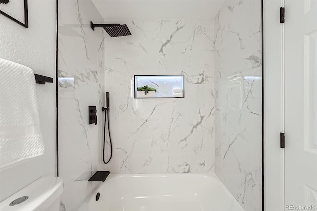 bathroom with tiled shower / bath combo and toilet