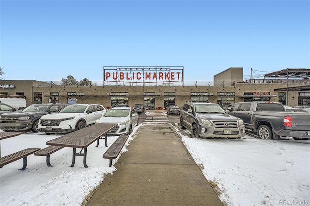 view of snow covered parking