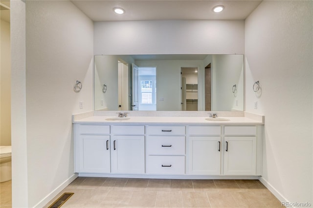 8595 Silverton Ln, Littleton, CO 80125 - bathroom featuring tile patterned flooring, vanity, and toilet