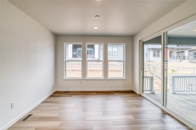 8595 Silverton Ln, Littleton, CO 80125 - empty room with light wood-type flooring and a textured ceiling