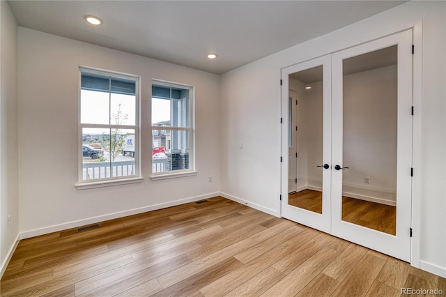 8595 Silverton Ln, Littleton, CO 80125 - empty room featuring french doors and light hardwood / wood-style flooring