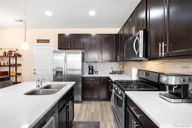 15546 W 64th Loop Unit C, Arvada, CO 80007 - kitchen featuring appliances with stainless steel finishes, dark brown cabinets, light wood-type flooring, tasteful backsplash, and recessed lighting