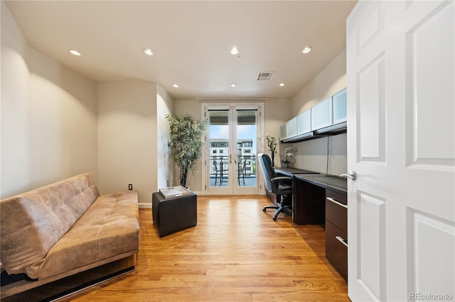 office area with light wood-style flooring, recessed lighting, french doors, and built in desk