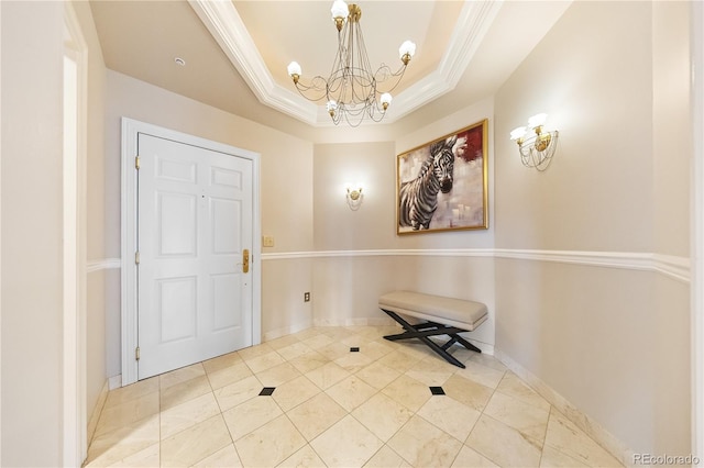 foyer entrance featuring a chandelier, a tray ceiling, light tile patterned flooring, and baseboards