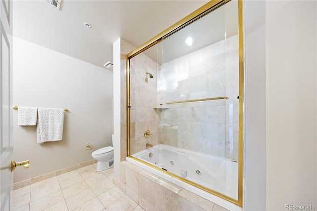 full bathroom featuring toilet, a combined bath / shower with jetted tub, tile patterned floors, and baseboards