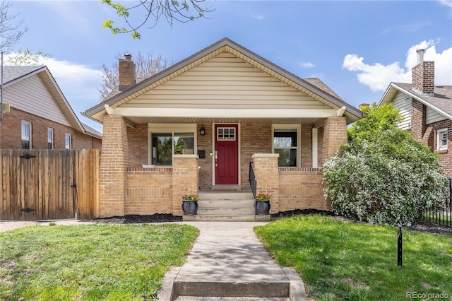 view of front facade with brick siding and covered porch