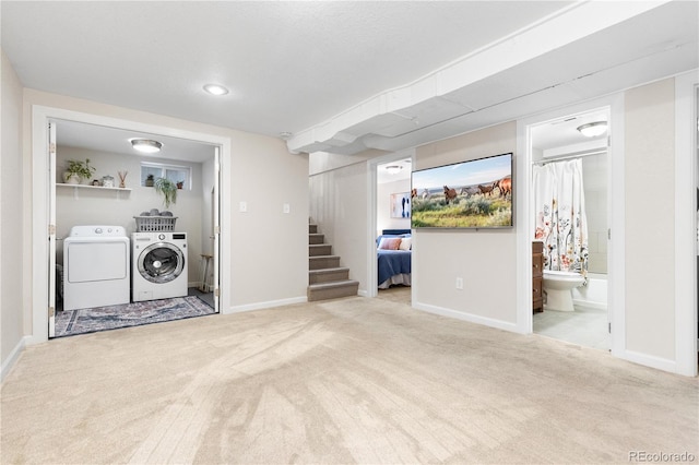 finished below grade area featuring washing machine and dryer, carpet, stairway, and baseboards