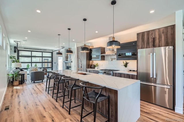 4474 Utica St, Denver, CO 80212 - kitchen with freestanding refrigerator, light wood finished floors, recessed lighting, a breakfast bar, and tasteful backsplash